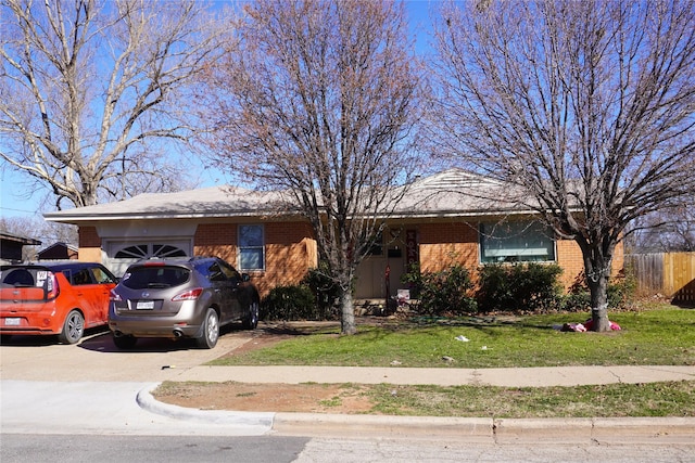 single story home featuring a garage and a front yard