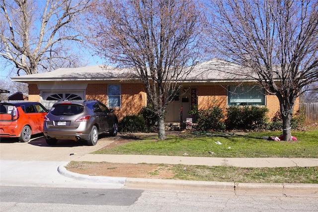 ranch-style home with a garage and a front lawn