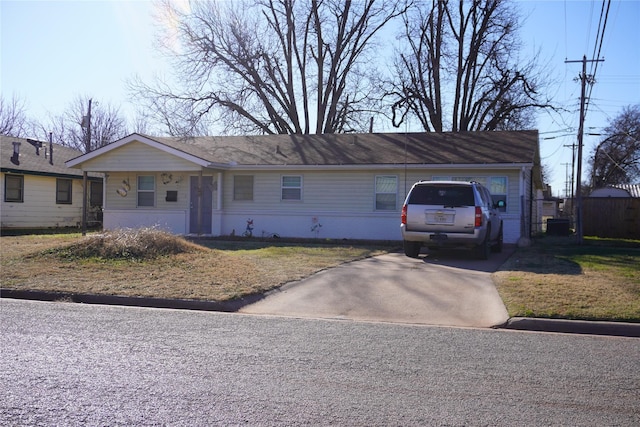 ranch-style home with a garage and a front yard