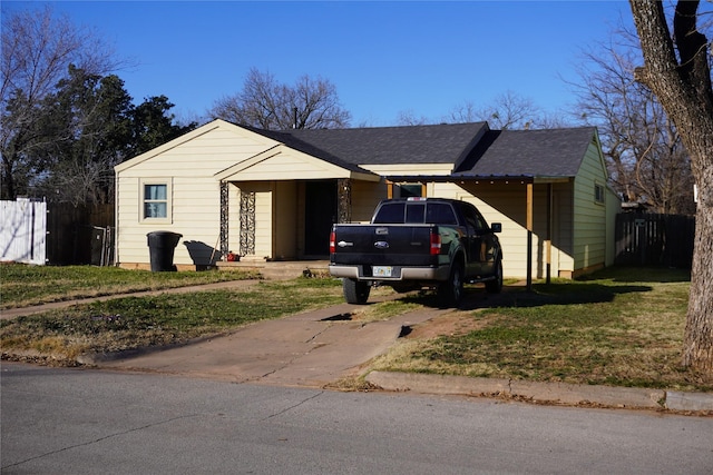 single story home featuring a carport and a front yard