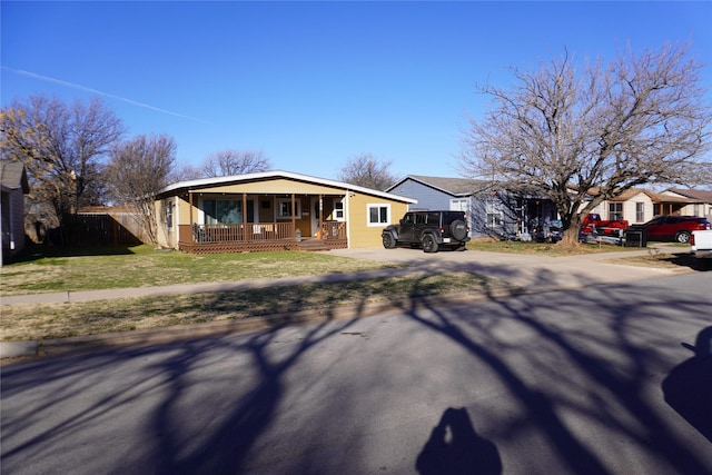 single story home with a front yard and covered porch