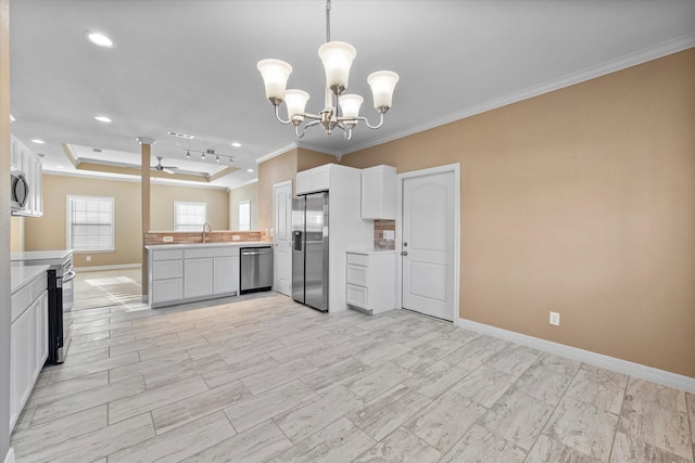 kitchen featuring pendant lighting, white cabinets, and appliances with stainless steel finishes