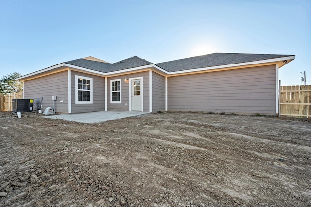 rear view of property featuring a patio and central air condition unit