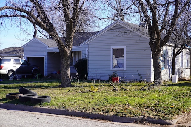 view of property exterior with a garage and a lawn