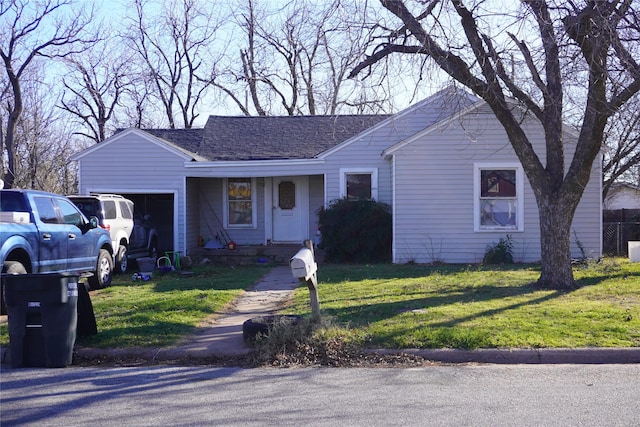 ranch-style house featuring a garage and a front yard