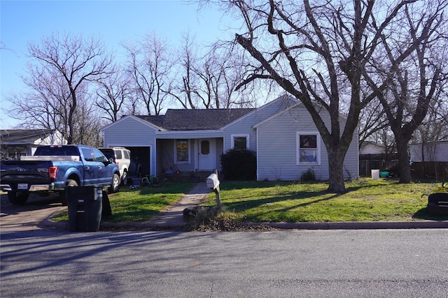 ranch-style house with a garage and a front lawn