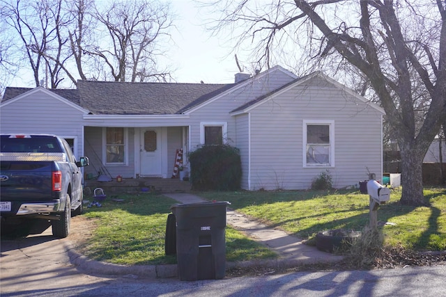 ranch-style home featuring a front yard