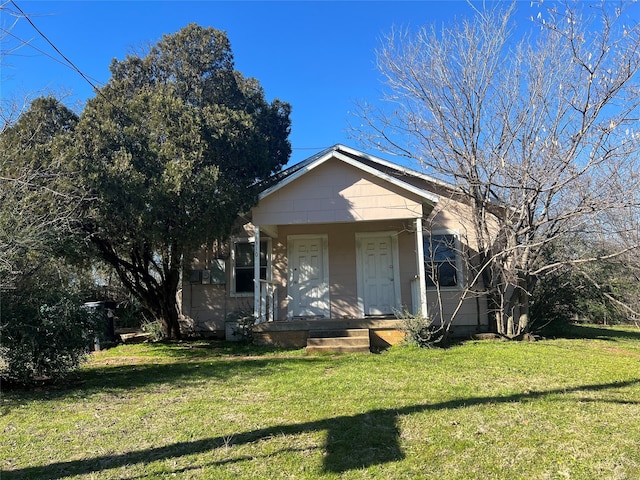 bungalow-style home with a front lawn