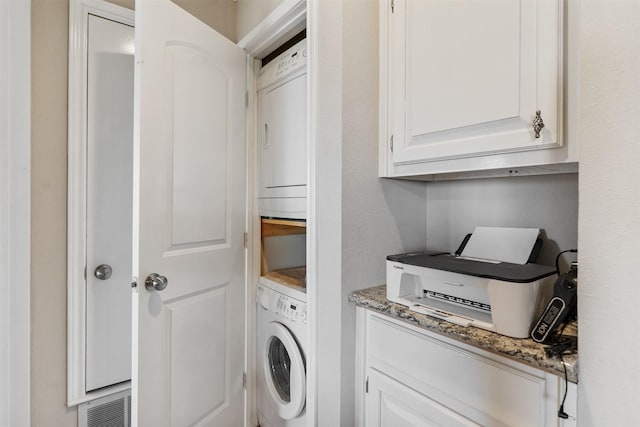 clothes washing area featuring washer / dryer and cabinets