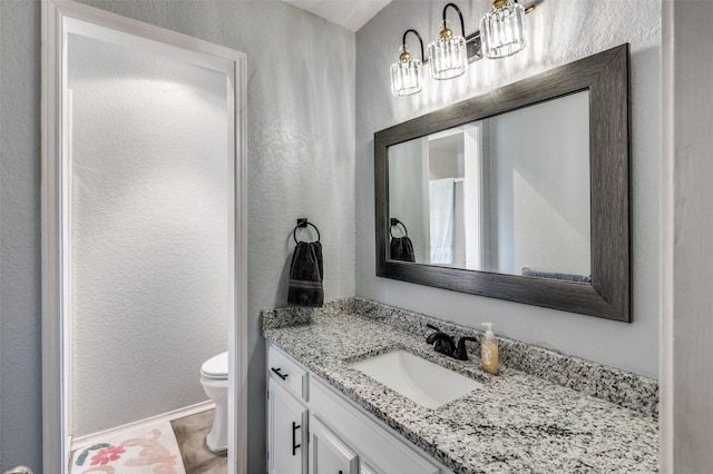 bathroom featuring vanity and toilet