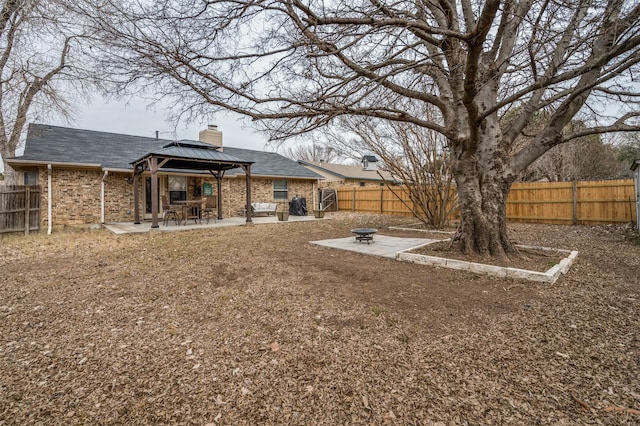 view of yard featuring a gazebo, a patio area, and an outdoor fire pit