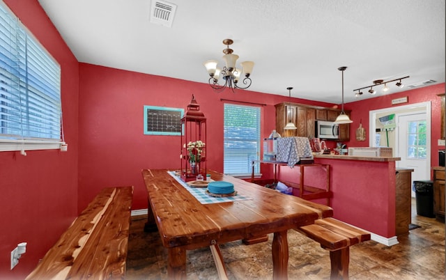 dining area featuring a notable chandelier