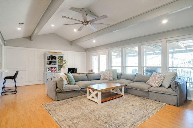 living room with vaulted ceiling with beams, french doors, ceiling fan, and light wood-type flooring