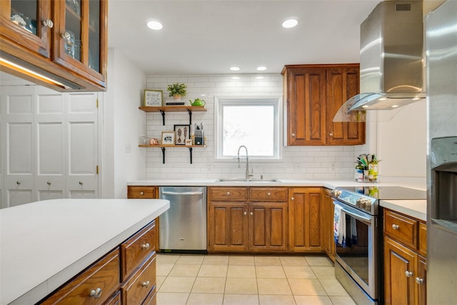 kitchen with sink, light tile patterned floors, backsplash, stainless steel appliances, and island range hood