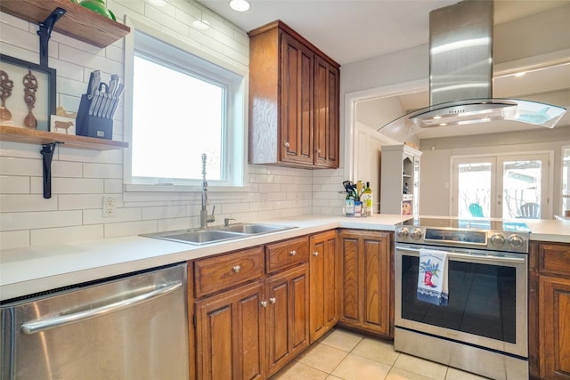 kitchen featuring appliances with stainless steel finishes, sink, decorative backsplash, island exhaust hood, and light tile patterned floors