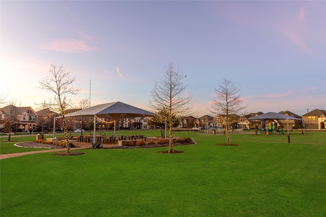 view of property's community featuring a playground, a gazebo, and a lawn