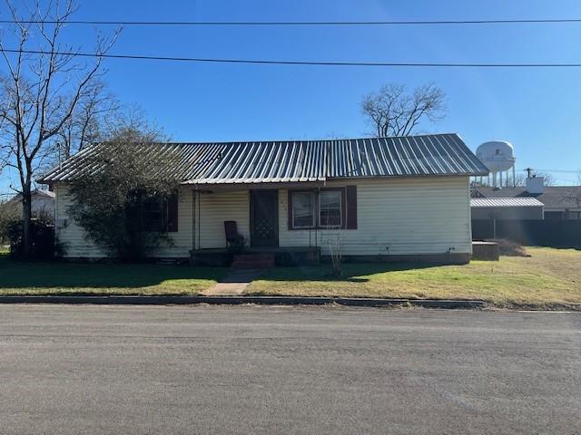 single story home featuring a front lawn