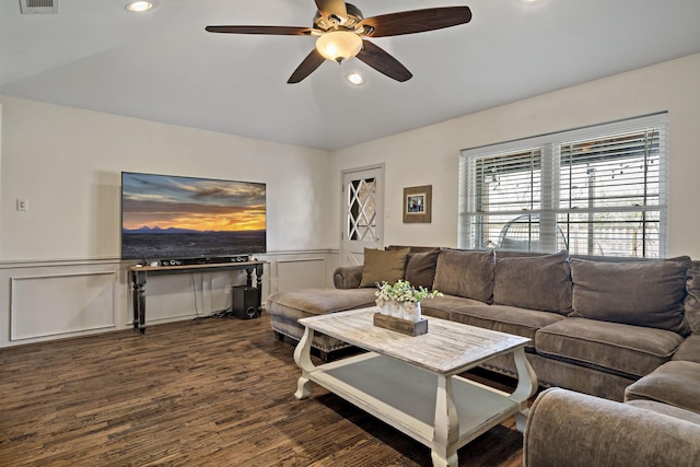 living room with ceiling fan and dark hardwood / wood-style flooring