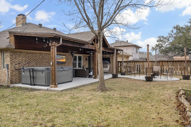 back of house featuring a yard, a hot tub, a patio, and ceiling fan