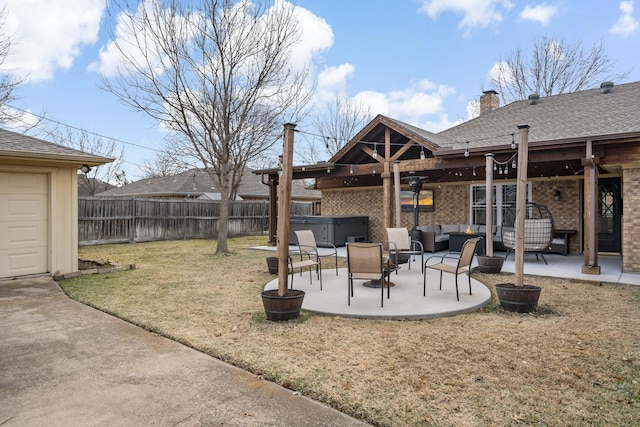 view of yard featuring a hot tub, a patio, and outdoor lounge area