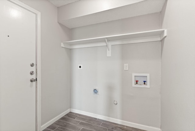 laundry room featuring dark wood-type flooring, hookup for a gas dryer, hookup for a washing machine, and electric dryer hookup