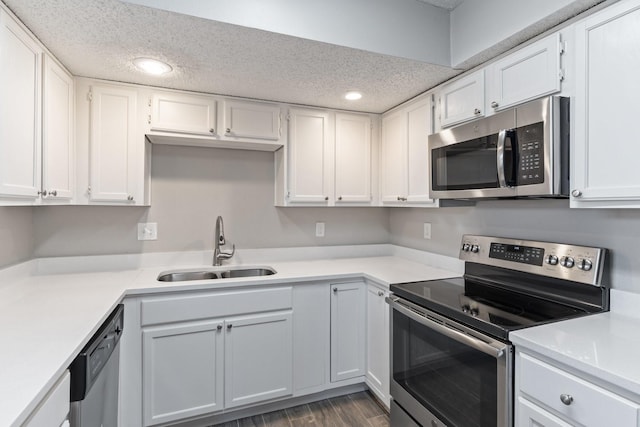 kitchen featuring white cabinetry, appliances with stainless steel finishes, sink, and a textured ceiling