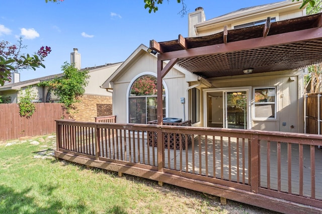 rear view of property featuring a deck