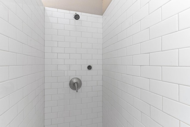 bathroom with a tile shower