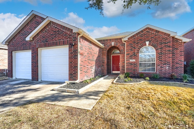 front of property featuring a garage and a front lawn