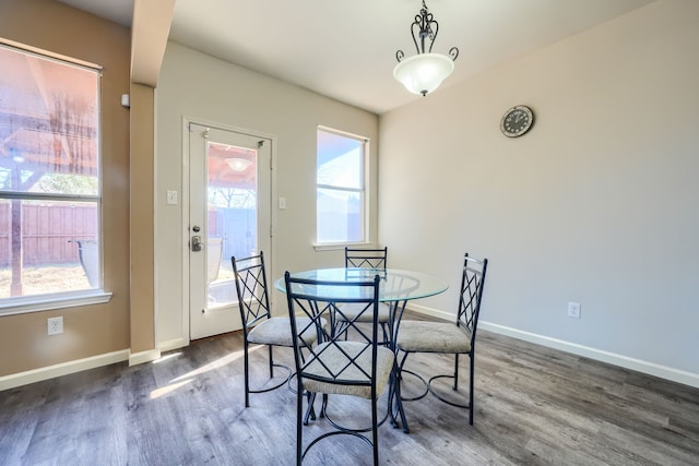 dining space with dark wood-type flooring