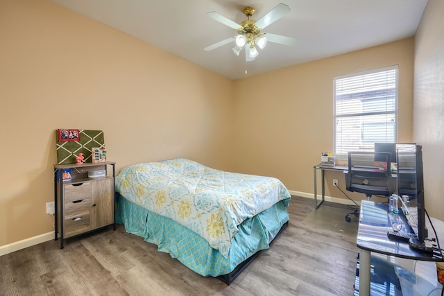 bedroom with hardwood / wood-style flooring and ceiling fan