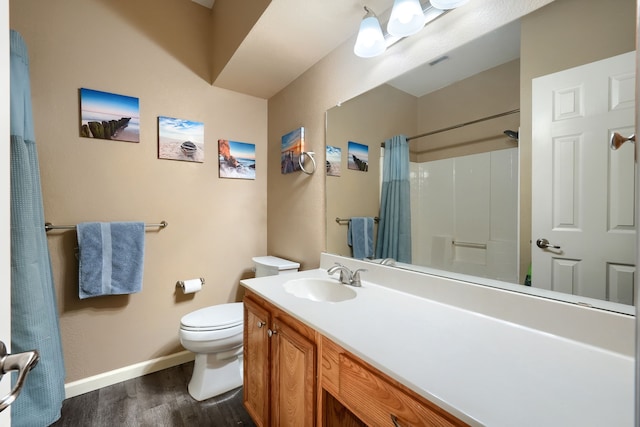 bathroom featuring wood-type flooring, toilet, curtained shower, and vanity