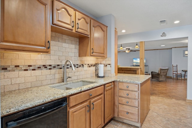 kitchen featuring sink, light tile patterned floors, light stone countertops, and dishwasher