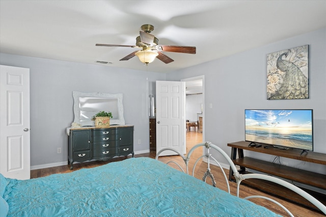 bedroom with dark wood-type flooring and ceiling fan