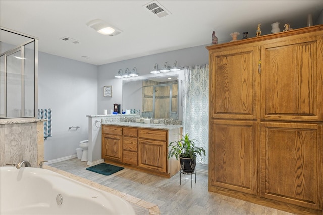 full bathroom with hardwood / wood-style flooring, vanity, toilet, and shower with separate bathtub