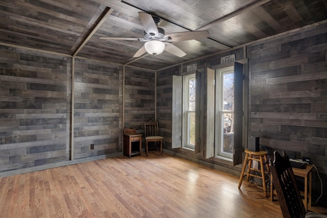 interior space with wood walls, hardwood / wood-style floors, and wooden ceiling