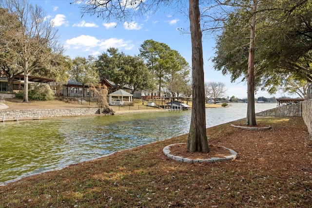 view of yard featuring a gazebo and a water view