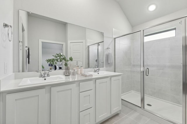 bathroom featuring vanity, an enclosed shower, vaulted ceiling, and tile patterned floors