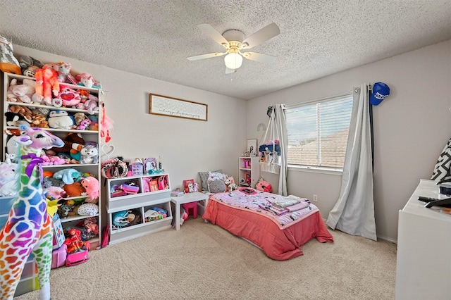 bedroom featuring ceiling fan, carpet floors, and a textured ceiling