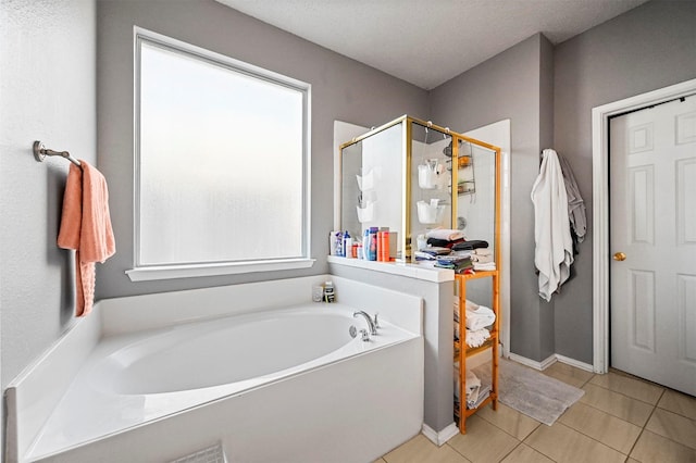 bathroom featuring shower with separate bathtub, tile patterned floors, and a textured ceiling