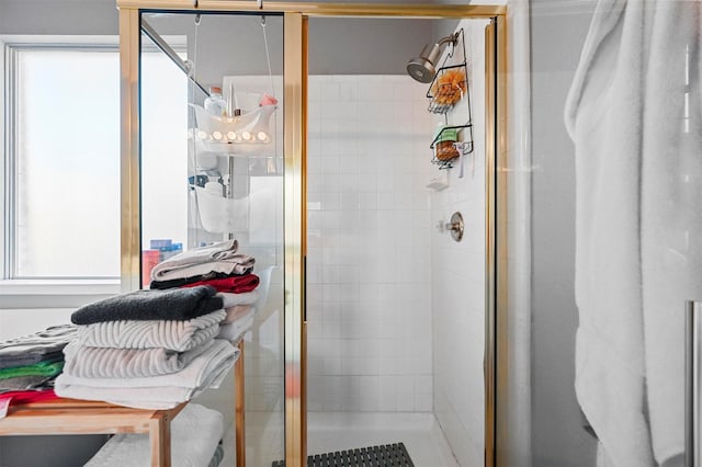 bathroom featuring a shower with shower door