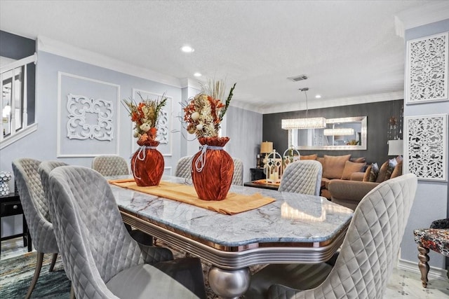 dining space featuring crown molding, a chandelier, and a textured ceiling