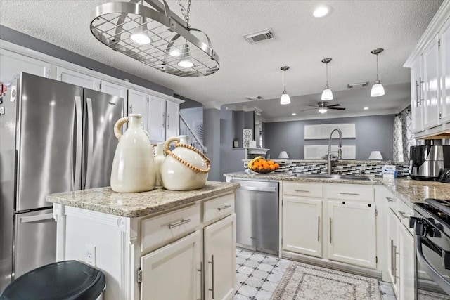 kitchen with a kitchen island, white cabinetry, hanging light fixtures, kitchen peninsula, and stainless steel appliances