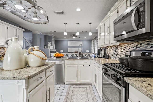 kitchen featuring stainless steel appliances, sink, and white cabinets