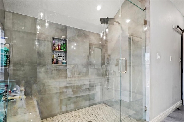 bathroom featuring a shower with door