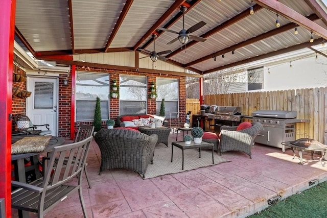 view of patio featuring grilling area, an outdoor living space with a fire pit, and ceiling fan