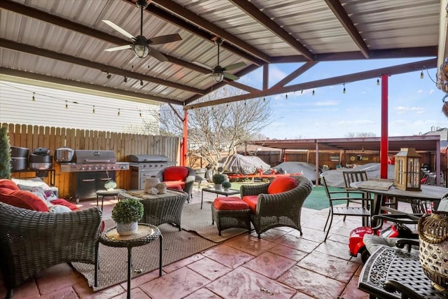 view of patio with an outdoor living space, exterior kitchen, area for grilling, and ceiling fan