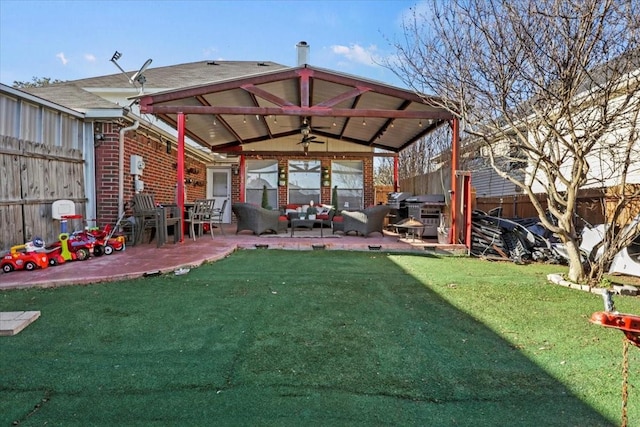 view of yard featuring an outdoor hangout area, a patio area, and ceiling fan