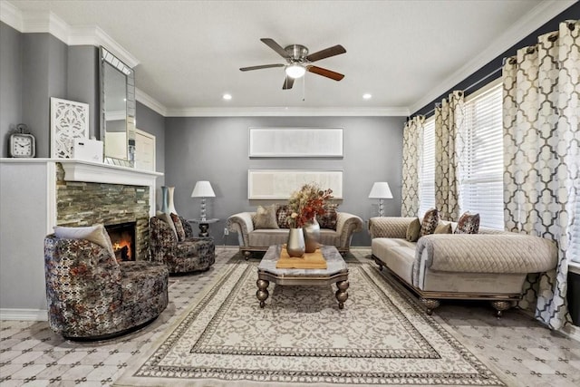 living room featuring crown molding, ceiling fan, and a stone fireplace