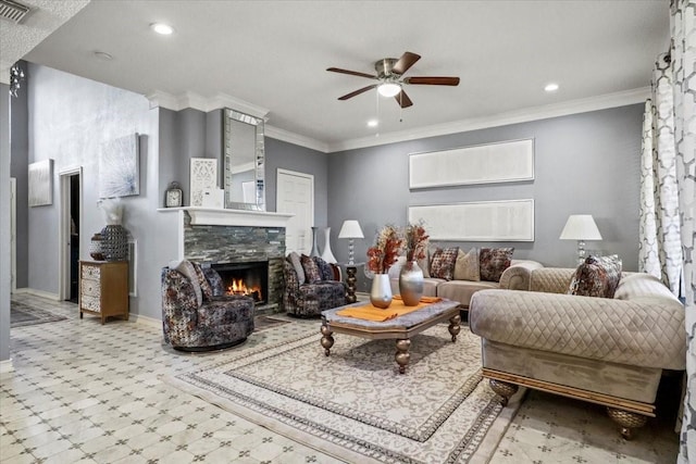 living room with crown molding, ceiling fan, and a fireplace